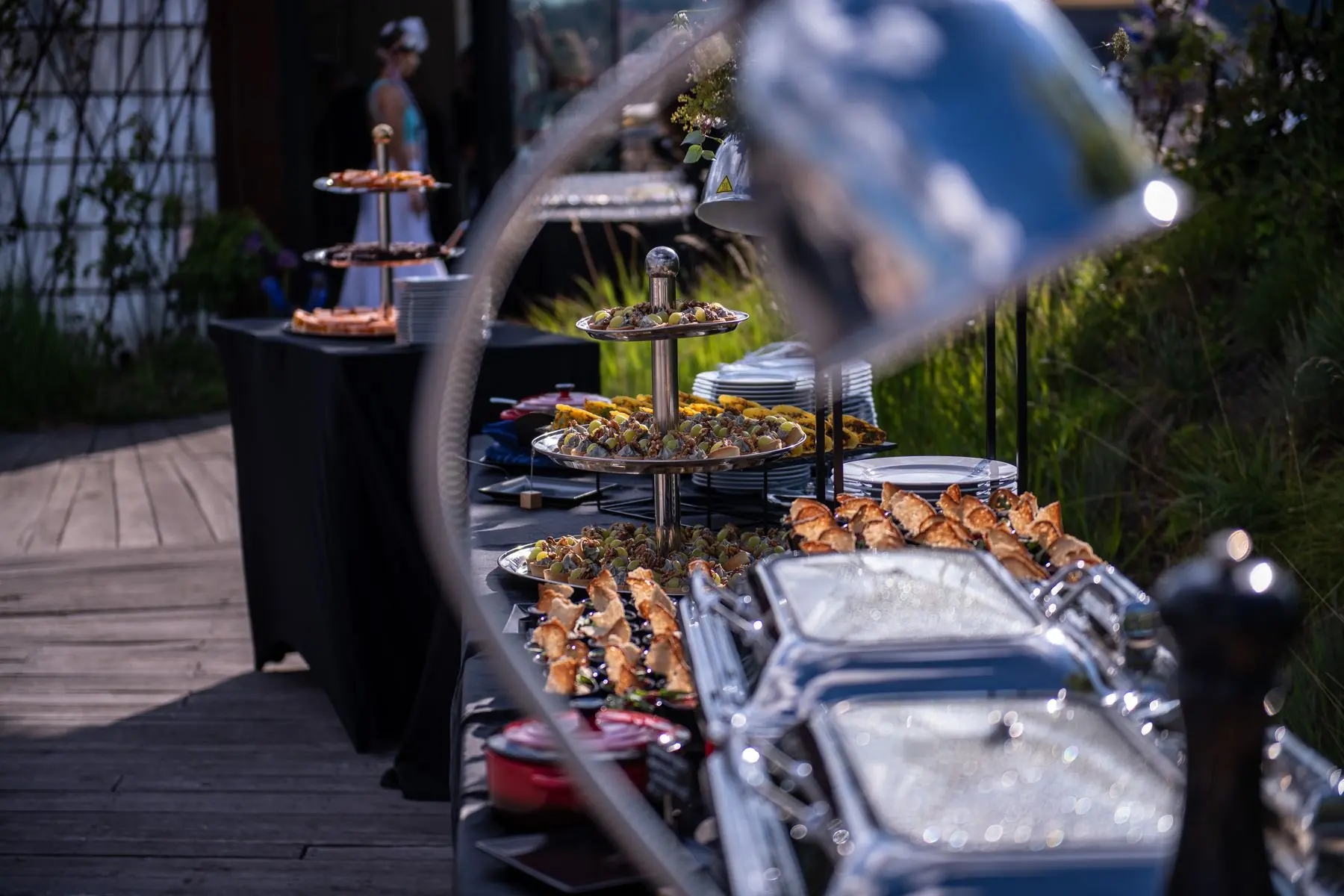 Rooftop buffet with tiered stands and chafing dishes