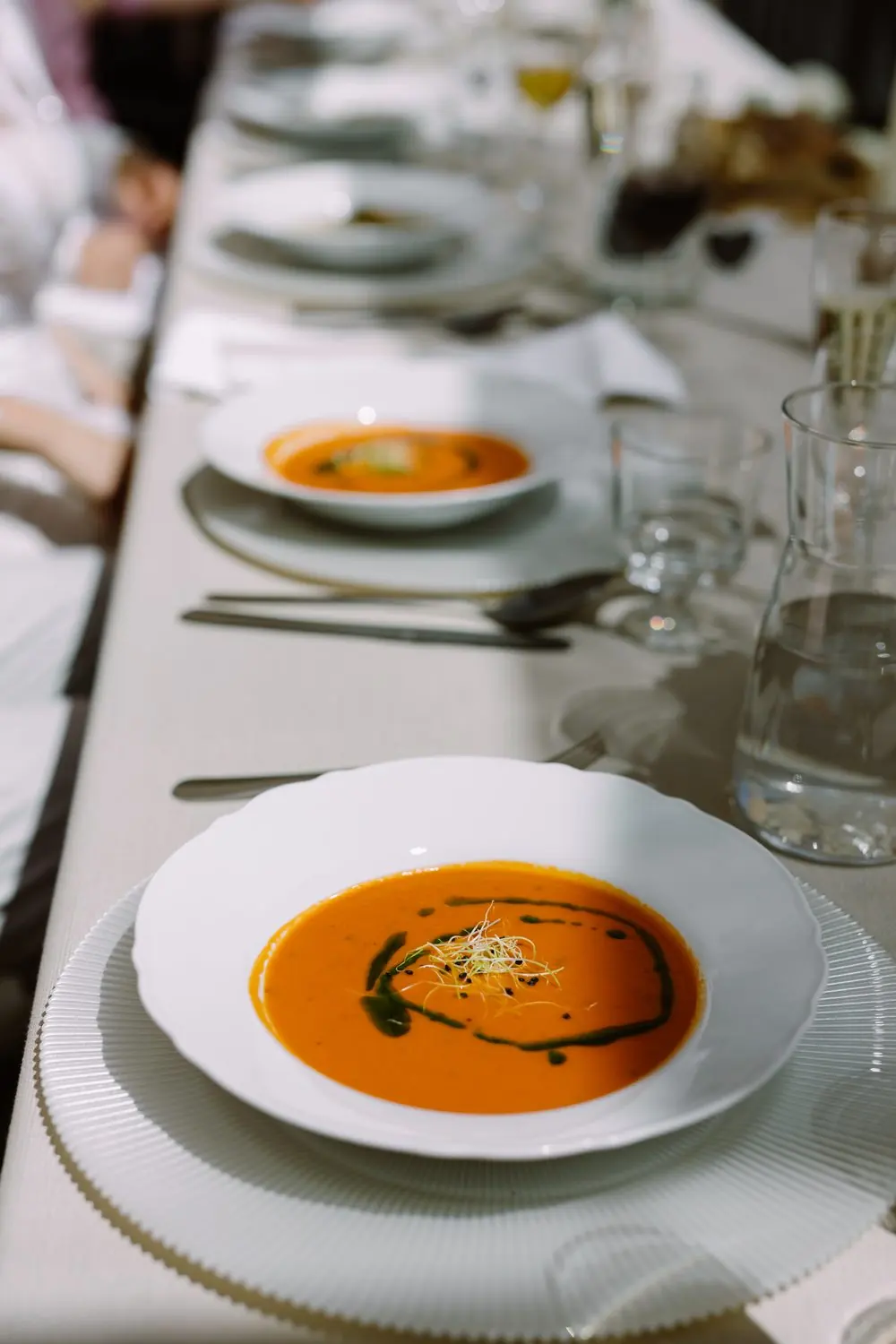 Tomato soup served at a long table